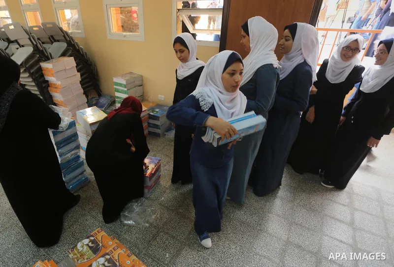Palestinian schoolgirls return back to their school in the morning of the first day of the new year study, in Gaza city, on August 28, 2016. Photo by Mohammed Asad