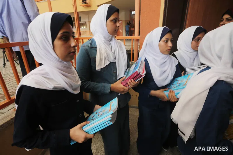 Palestinian schoolgirls return back to their school in the morning of the first day of the new year study, in Gaza city, on August 28, 2016. Photo by Mohammed Asad