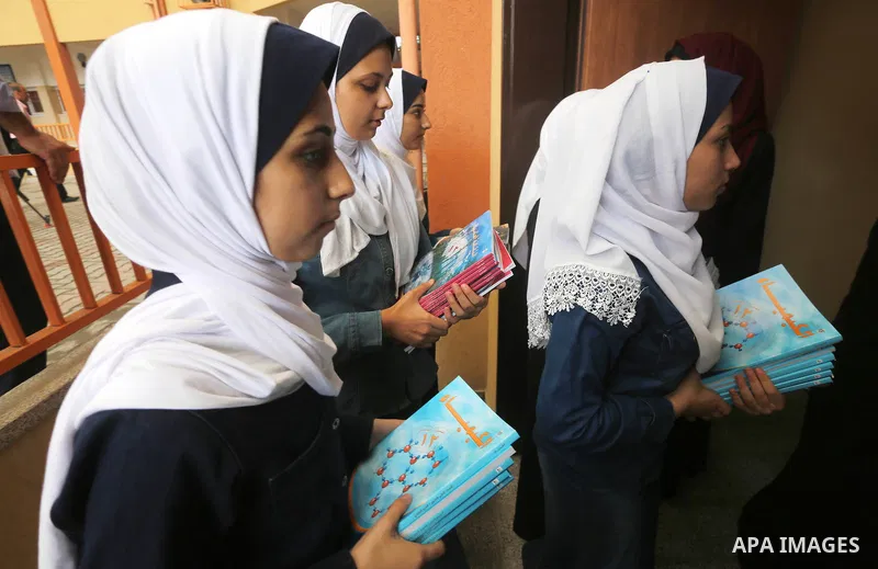 Palestinian schoolgirls return back to their school in the morning of the first day of the new year study, in Gaza city, on August 28, 2016. Photo by Mohammed Asad
