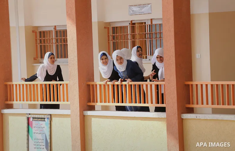 Palestinian schoolgirls return back to their school in the morning of the first day of the new year study, in Gaza city, on August 28, 2016. Photo by Mohammed Asad