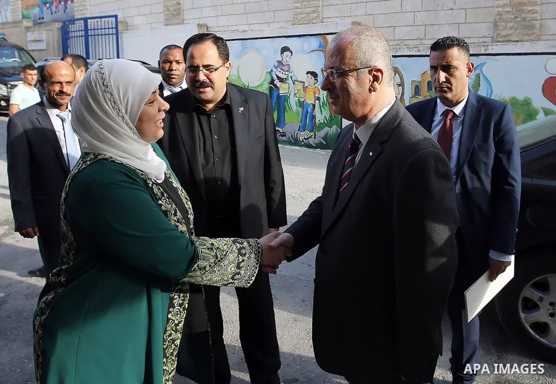 Palestinian Prime Minister Rami Hamdallah visits a school during the first day of the new school year in the West Bank city of Ramallah, on August 28, 2016. Photo by Prime Minister Office