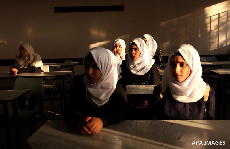 Palestinian schoolgirls attend a lesson in a classroom on the first day of a new school year, at a United Nations-run school in Khan Younis in the southern Gaza Strip August 28, 2016. Photo by Ashraf Amra