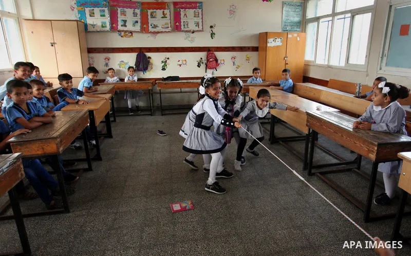 Palestinian schoolchildren play a game in a classroom on the first day of a new school year, at a United Nations-run school in Khan Younis in the southern Gaza Strip August 28, 2016. Photo by Ashraf Amra