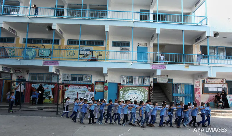 Palestinian students return back to their school in the morning of the first day of the new year study in Khan Younis in the southern Gaza Strip August 28, 2016. Photo by Ashraf Amra