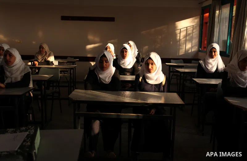 Palestinian schoolgirls attend a lesson in a classroom on the first day of a new school year, at a United Nations-run school in Khan Younis in the southern Gaza Strip August 28, 2016. Photo by Ashraf Amra