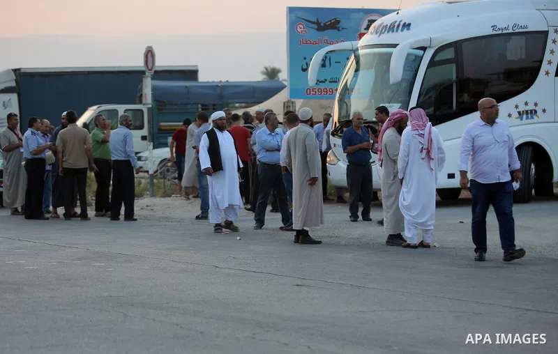 Palestinians Muslim pilgrims wait at Al-Karama crossing between the West Bank and Jordan near Jericho, on August 28, 2016, before leaving for the annual hajj pilgrimage to the holy city of Mecca. Hundreds of Palestinian...