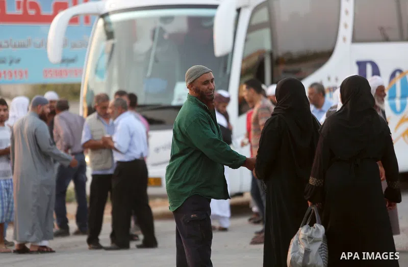 Palestinians Muslim pilgrims wait at Al-Karama crossing between the West Bank and Jordan near Jericho, on August 28, 2016, before leaving for the annual hajj pilgrimage to the holy city of Mecca. Hundreds of Palestinian...