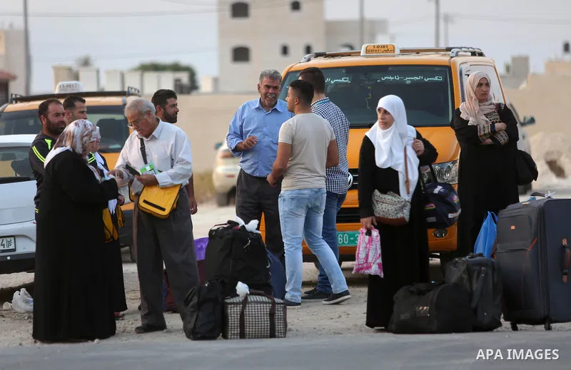 Palestinians Muslim pilgrims wait at Al-Karama crossing between the West Bank and Jordan near Jericho, on August 28, 2016, before leaving for the annual hajj pilgrimage to the holy city of Mecca. Hundreds of Palestinian...
