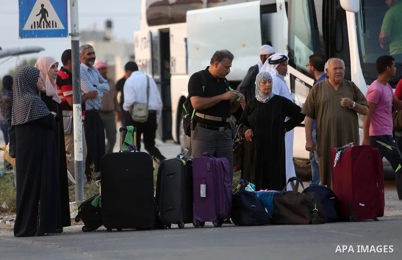 Palestinians Muslim pilgrims wait at Al-Karama crossing between the West Bank and Jordan near Jericho, on August 28, 2016, before leaving for the annual hajj pilgrimage to the holy city of Mecca. Hundreds of Palestinian...