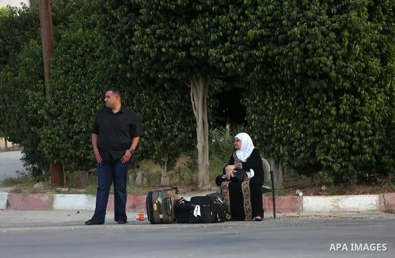 Palestinians Muslim pilgrims wait at Al-Karama crossing between the West Bank and Jordan near Jericho, on August 28, 2016, before leaving for the annual hajj pilgrimage to the holy city of Mecca. Hundreds of Palestinian...