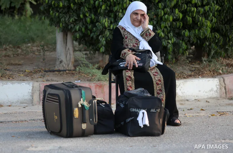Palestinians Muslim pilgrims wait at Al-Karama crossing between the West Bank and Jordan near Jericho, on August 28, 2016, before leaving for the annual hajj pilgrimage to the holy city of Mecca. Hundreds of Palestinian...