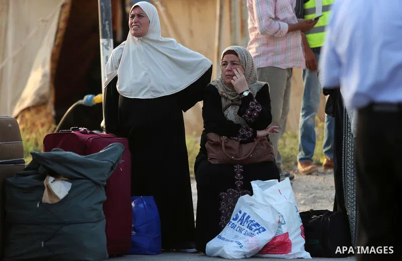 Palestinians Muslim pilgrims wait at Al-Karama crossing between the West Bank and Jordan near Jericho, on August 28, 2016, before leaving for the annual hajj pilgrimage to the holy city of Mecca. Hundreds of Palestinian...