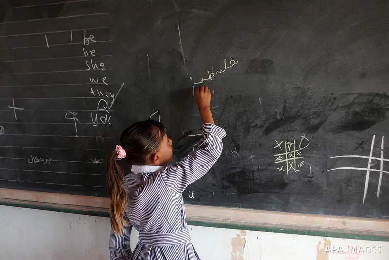 A Palestinian Bedouin Student learns at Arab Al-Ka'abneh school in Al-Mu'arrajat area near the West Bank city of Jericho, on the first day of a new school year on Aug. 28, 2016. Dozens of Palestinian children in the rams...