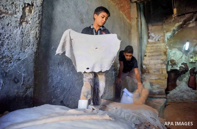Egyptian leather tannery workers, salt the hides of animals before drying them, at a leather tannery, in Cairo, Egypt, on August 28, 2016. Photo by Amr Sayed
