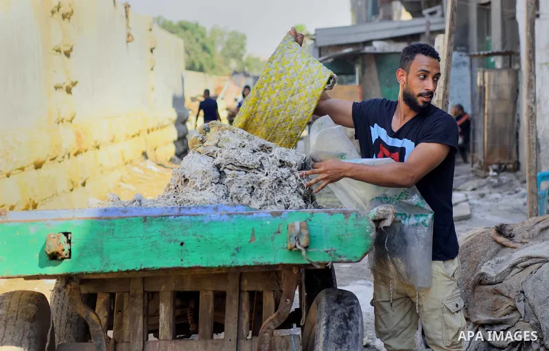 Egyptian leather tannery workers, salt the hides of animals before drying them, at a leather tannery, in Cairo, Egypt, on August 28, 2016. Photo by Amr Sayed