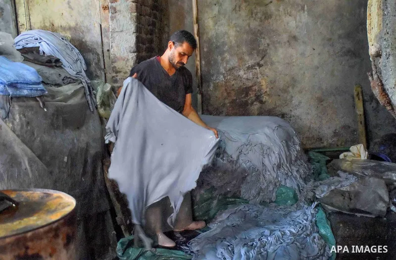 Egyptian leather tannery workers, salt the hides of animals before drying them, at a leather tannery, in Cairo, Egypt, on August 28, 2016. Photo by Amr Sayed