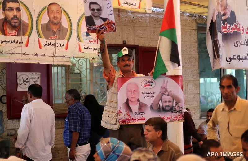 Palestinians take part in a protest demanding release the prisoners in Israeli jails, in front of Red cross office in Gaza city, on August 29, 2016. Photo by Mohammed Asad