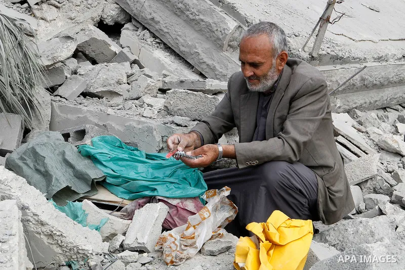 A Palestinian man inspects the rubble of the home of Mohammed Abed Almajid El-Amaira, a Palestinian accused of involvement in a shooting attack that led to the death of a rabbi, after it was destroyed by Israeli military...