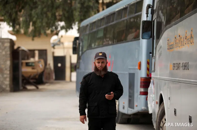 A member of Palestinian security forces loyal to Hamas stands guard as the bus of Palestinian Muslim pilgrims leaving the Rafah border crossing between Egypt and the southern Gaza Strip, on August 30, 2016, ahead of her...