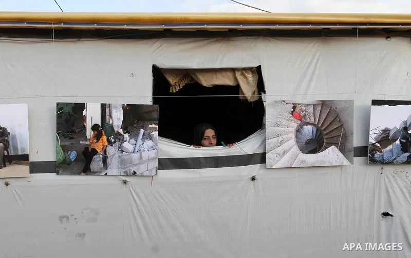 Palestinians attend the photographic exhibition "houses without columns", in Khuza'a, in the east of the town of Khan Younis in southern Gaza Strip, on August 30, 2016. Photo by Abed Rahim Khatib