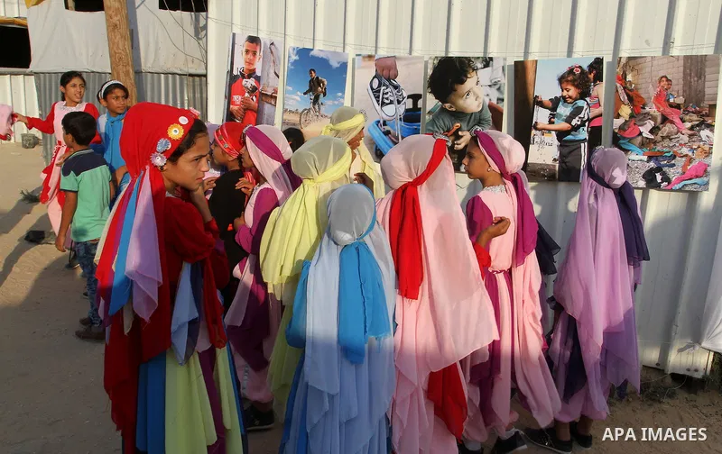 Palestinians attend the photographic exhibition "houses without columns", in Khuza'a, in the east of the town of Khan Younis in southern Gaza Strip, on August 30, 2016. Photo by Abed Rahim Khatib