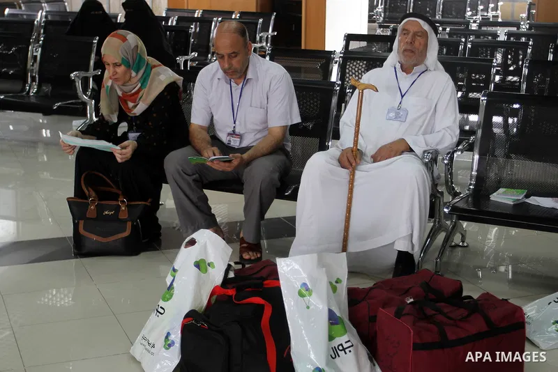 Palestinian Muslim pilgrims wait at the Rafah border crossing between Egypt and the southern Gaza Strip, on August 31, 2016 ahead of their departure to the annual Hajj pilgrimage in Saudi Arabia's holy city of Mecca. Pho...