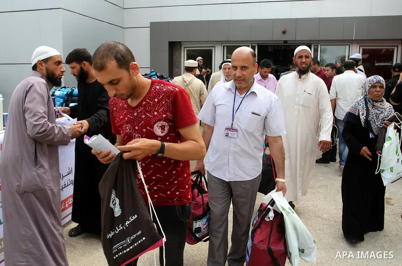 Palestinian Muslim pilgrims arrive at the Rafah border crossing between Egypt and the southern Gaza Strip, on August 31, 2016 ahead of their departure to the annual Hajj pilgrimage in Saudi Arabia's holy city of Mecca. P...