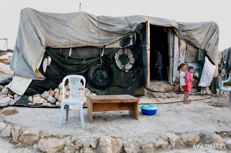 Palestinian children play outside their a tent in the West Bank village of Sosiya, south of Hebron, on September 1 2016, villages in Yatta area south of Hebron suffer from lack of schools and transportations and students...