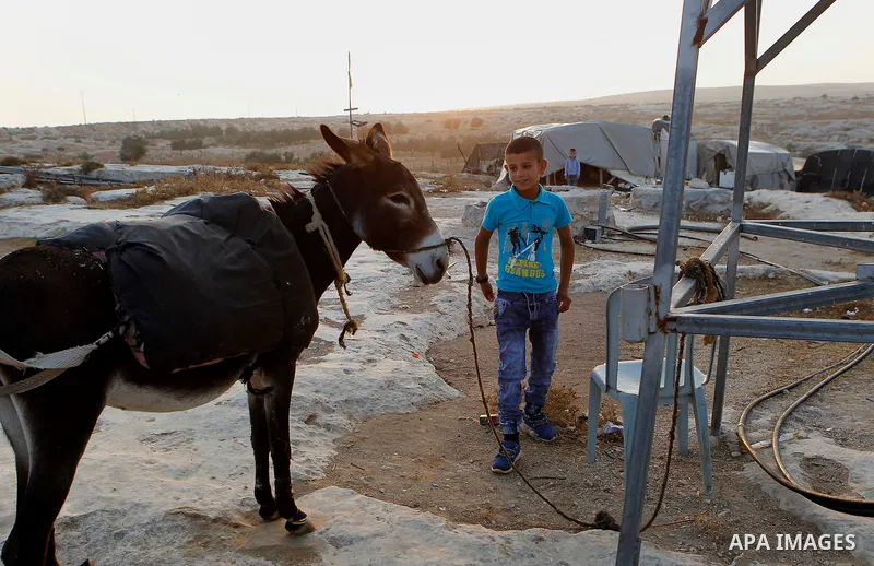 Palestinian school students go to school in the West Bank village of Sosiya, south of Hebron, on September 1 2016, villages in Yatta area south of Hebron suffer from lack of schools and transportations and students have...