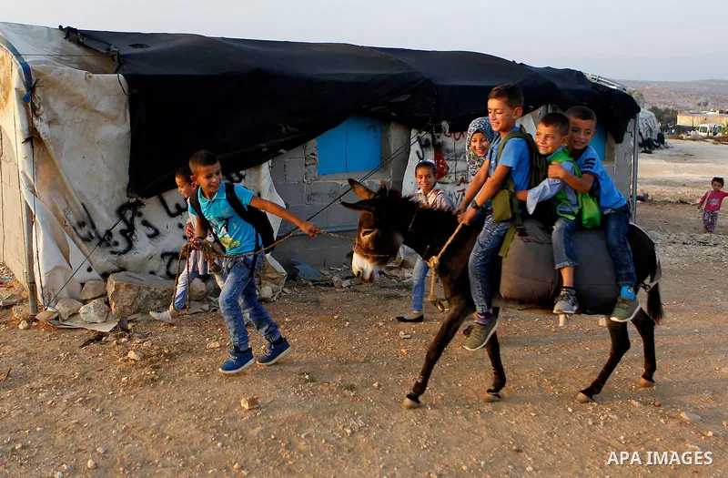 Palestinian school students go to school in the West Bank village of Sosiya, south of Hebron, on September 1 2016, villages in Yatta area south of Hebron suffer from lack of schools and transportations and students have...