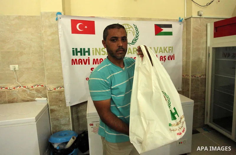 Palestinians receive free meals during the opening ceremony of a kitchen martyrs of the Freedom Flotilla (Mavi Marmara), which provides free meals for poor families, in Gaza city, on Sept. 01, 2016. Photo by Ashraf Amra