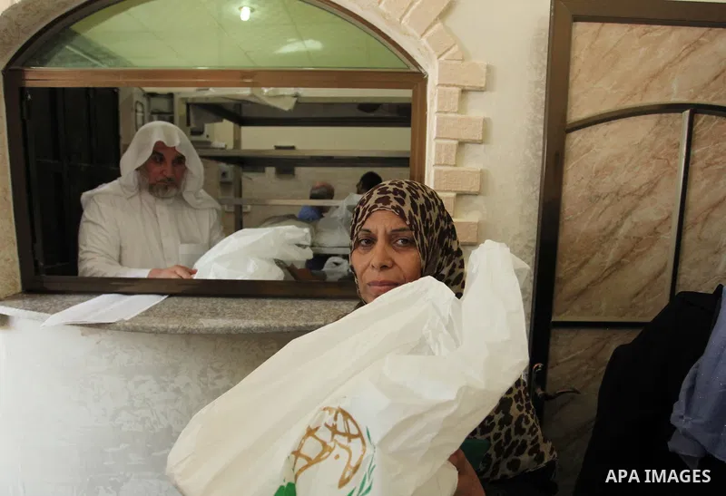 Palestinians receive free meals during the opening ceremony of a kitchen martyrs of the Freedom Flotilla (Mavi Marmara), which provides free meals for poor families, in Gaza city, on Sept. 01, 2016. Photo by Ashraf Amra