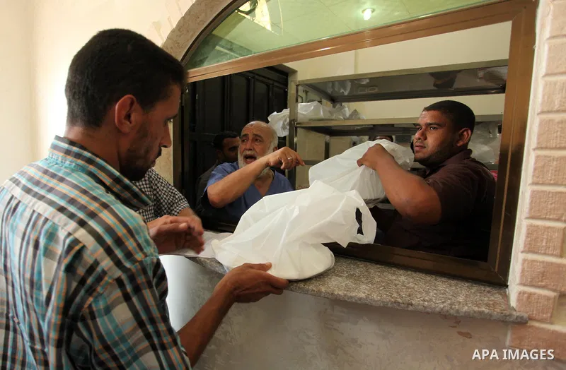 Palestinians receive free meals during the opening ceremony of a kitchen martyrs of the Freedom Flotilla (Mavi Marmara), which provides free meals for poor families, in Gaza city, on Sept. 01, 2016. Photo by Ashraf Amra