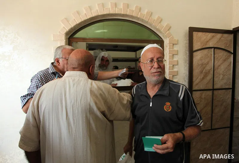 Palestinians receive free meals during the opening ceremony of a kitchen martyrs of the Freedom Flotilla (Mavi Marmara), which provides free meals for poor families, in Gaza city, on Sept. 01, 2016. Photo by Ashraf Amra