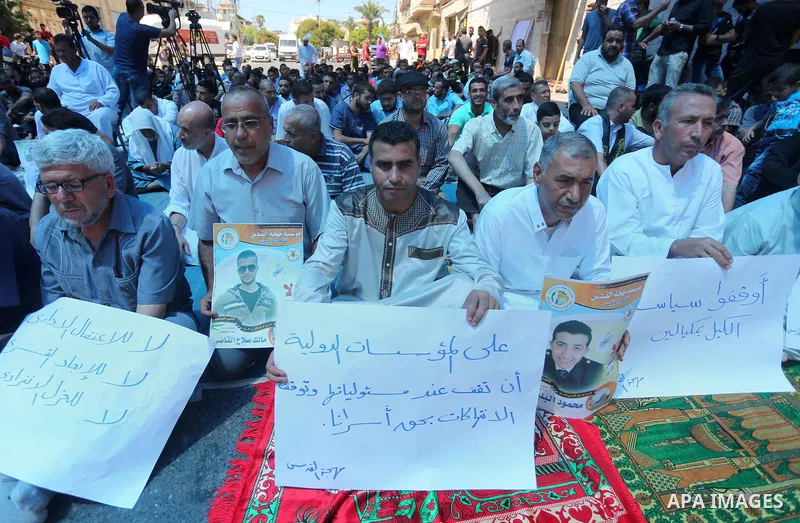 Palestinian supporters of the Islamic Jihad Movement attend Friday prayers to show solidarity with Palestinian prisoners in Israeli Jails, in front of Red cross office in Gaza city, on Sep. 02, 2016. Photo by Mohammed As...