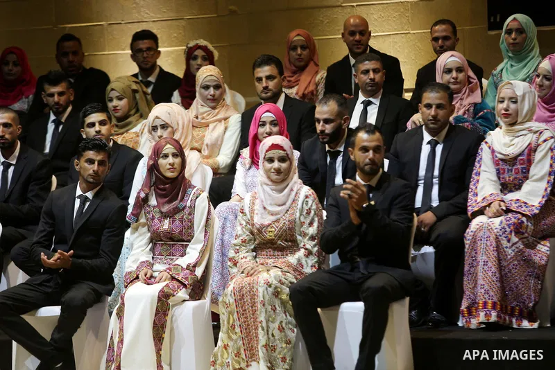 Palestinian grooms and brides take part in a mass wedding ceremony in the West Bank city of Ramallah, on Sep. 02, 2016. Nearly 25 Palestinian couples were married in a ceremony supported by Palestinian President Mahmoud...