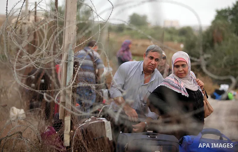 Palestinians wait for travel permits to cross into Egypt through the Rafah border crossing after it was opened by Egyptian authorities, in the southern Gaza Strip September 3, 2016. Photo by Ashraf Amra
