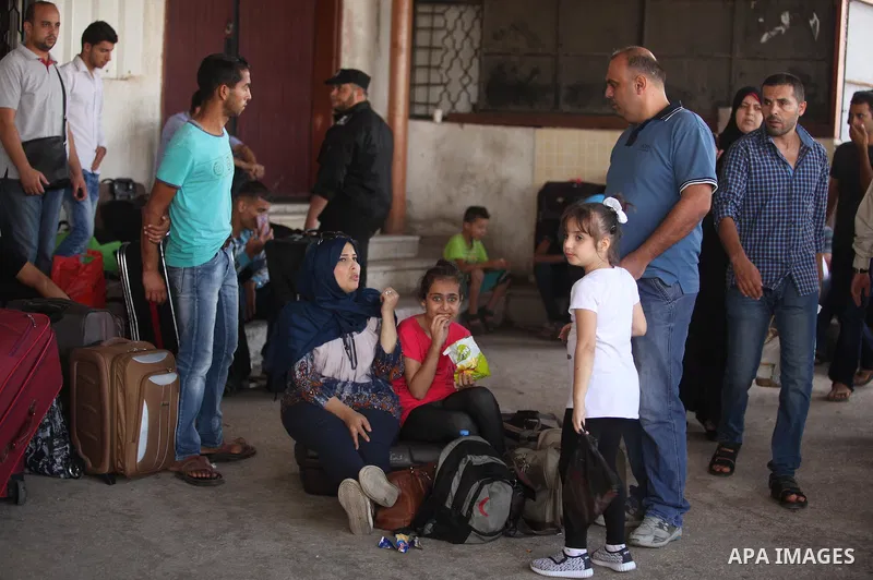 Palestinians wait for travel permits to cross into Egypt through the Rafah border crossing after it was opened by Egyptian authorities, in the southern Gaza Strip September 3, 2016. Photo by Ashraf Amra