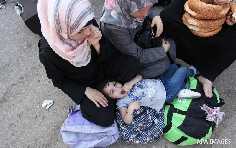 Palestinians wait for travel permits to cross into Egypt through the Rafah border crossing after it was opened by Egyptian authorities, in the southern Gaza Strip September 3, 2016. Photo by Ashraf Amra