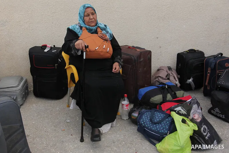 Palestinians wait for travel permits to cross into Egypt through the Rafah border crossing after it was opened by Egyptian authorities, in the southern Gaza Strip September 3, 2016. Photo by Ashraf Amra