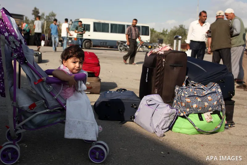 Palestinians wait for travel permits to cross into Egypt through the Rafah border crossing after it was opened by Egyptian authorities, in the southern Gaza Strip September 3, 2016. Photo by Ashraf Amra
