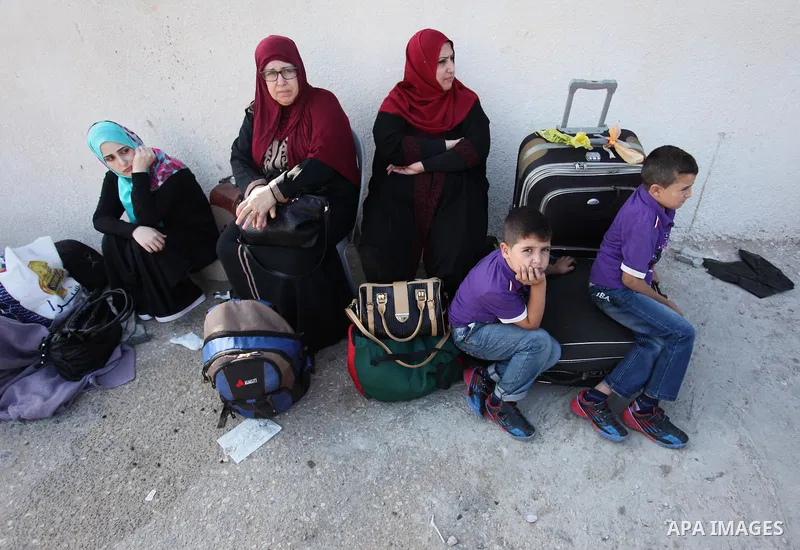 Palestinians wait for travel permits to cross into Egypt through the Rafah border crossing after it was opened by Egyptian authorities, in the southern Gaza Strip September 3, 2016. Photo by Ashraf Amra