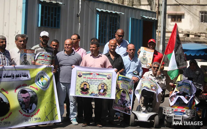 Palestinians hold banners during a protest to show solidarity with Palestinian prisoners on hunger strike in Israeli Jails, in front of the high commissioner for human rights headquarters in Gaza City, on Sept. 04, 2016....