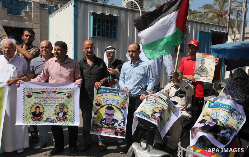 Palestinians hold banners during a protest to show solidarity with Palestinian prisoners on hunger strike in Israeli Jails, in front of the high commissioner for human rights headquarters in Gaza City, on Sept. 04, 2016....
