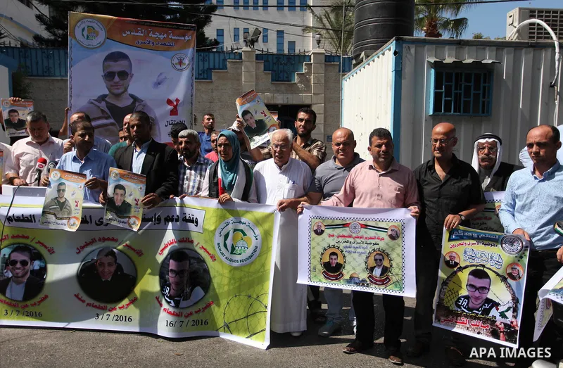 Palestinians hold banners during a protest to show solidarity with Palestinian prisoners on hunger strike in Israeli Jails, in front of the high commissioner for human rights headquarters in Gaza City, on Sept. 04, 2016....