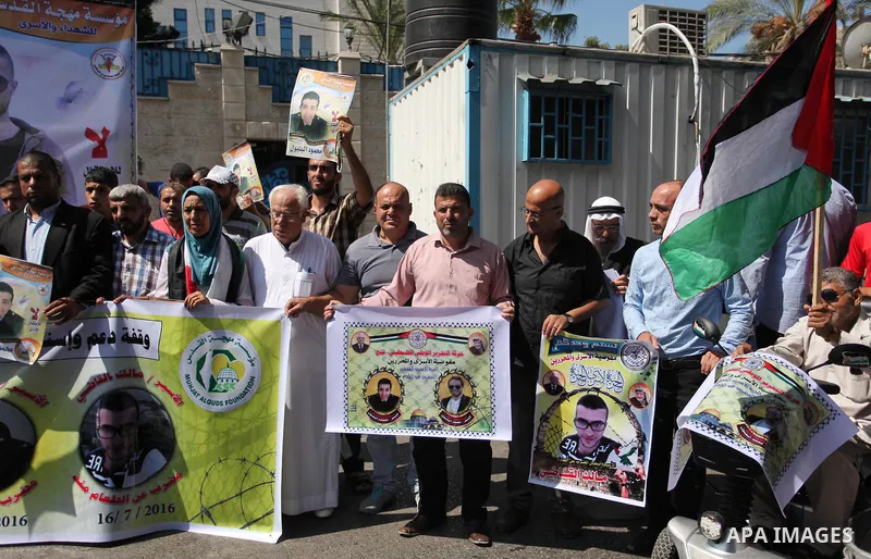 Palestinians hold banners during a protest to show solidarity with Palestinian prisoners on hunger strike in Israeli Jails, in front of the high commissioner for human rights headquarters in Gaza City, on Sept. 04, 2016....