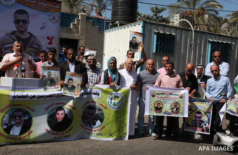 Palestinians hold banners during a protest to show solidarity with Palestinian prisoners on hunger strike in Israeli Jails, in front of the high commissioner for human rights headquarters in Gaza City, on Sept. 04, 2016....