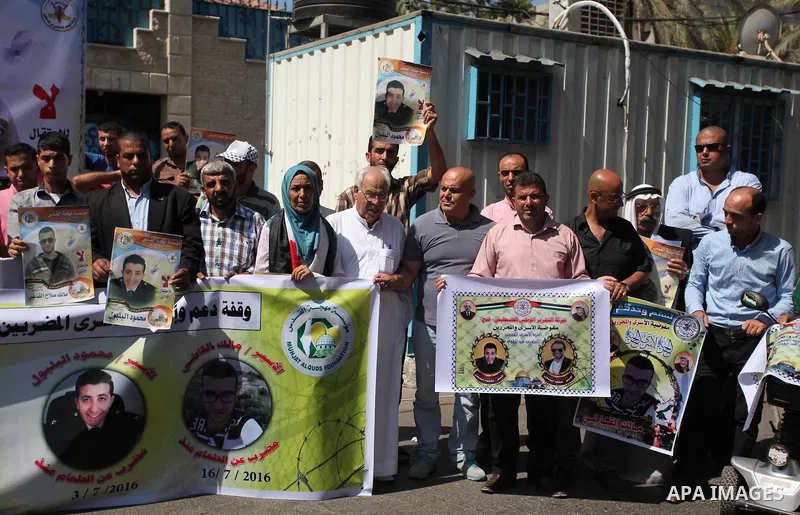 Palestinians hold banners during a protest to show solidarity with Palestinian prisoners on hunger strike in Israeli Jails, in front of the high commissioner for human rights headquarters in Gaza City, on Sept. 04, 2016....