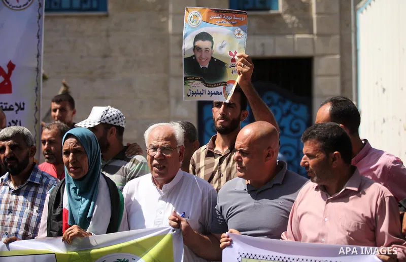Palestinians hold banners during a protest to show solidarity with Palestinian prisoners on hunger strike in Israeli Jails, in front of the high commissioner for human rights headquarters in Gaza City, on Sept. 04, 2016....