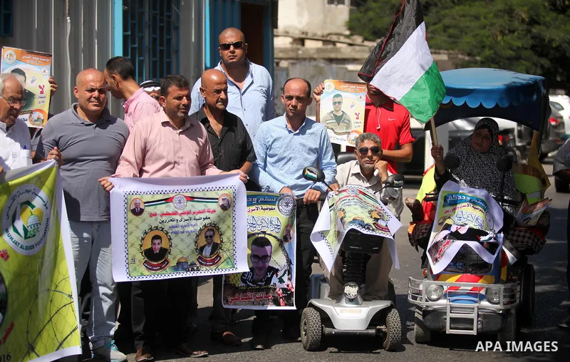 Palestinians hold banners during a protest to show solidarity with Palestinian prisoners on hunger strike in Israeli Jails, in front of the high commissioner for human rights headquarters in Gaza City, on Sept. 04, 2016....